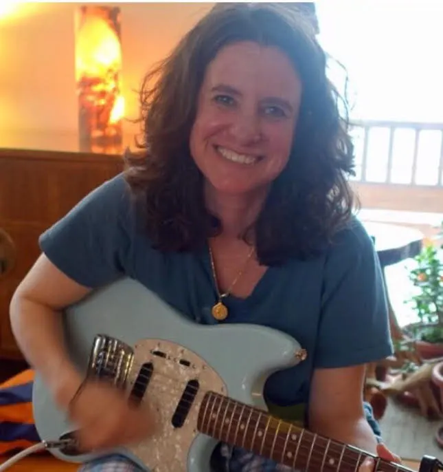 Shanti playing electric guitar